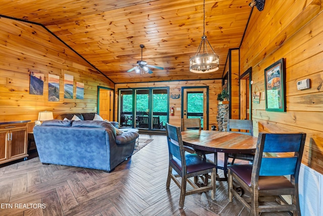 dining area with wood ceiling, wooden walls, lofted ceiling, and ceiling fan