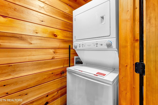 washroom with laundry area and stacked washer / drying machine