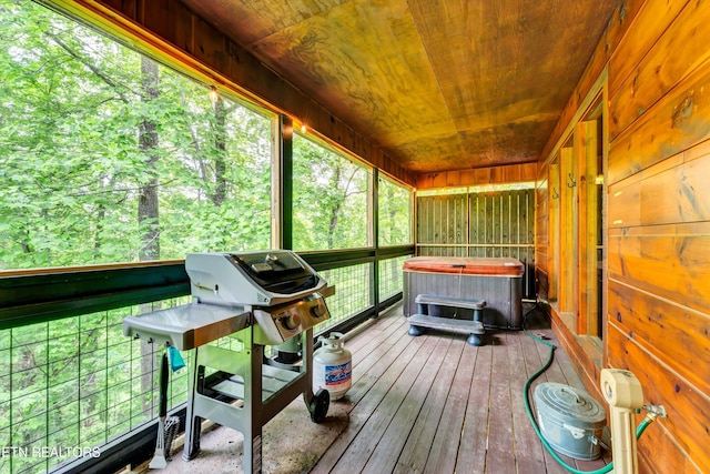 sunroom featuring a hot tub