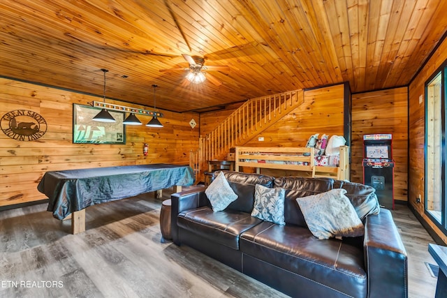 playroom featuring wooden ceiling, wood walls, wood finished floors, and a ceiling fan