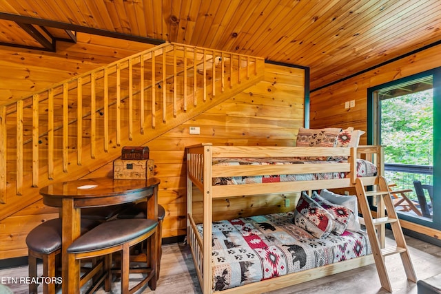 bedroom featuring wood walls and wood ceiling