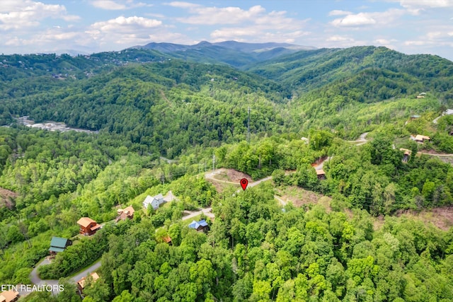 drone / aerial view featuring a view of trees and a mountain view