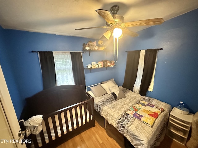bedroom with wood finished floors and a ceiling fan