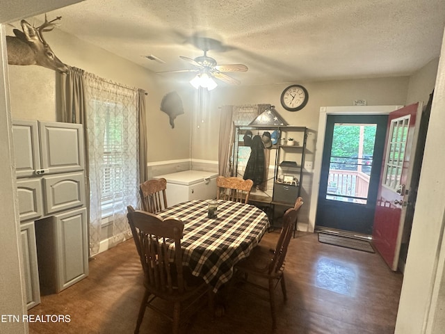 dining area with a textured ceiling and a ceiling fan