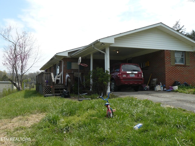 115 Standifer Ln, Tazewell, TN 37879 - view of property exterior featuring brick siding, driveway, fence, and an attached carport