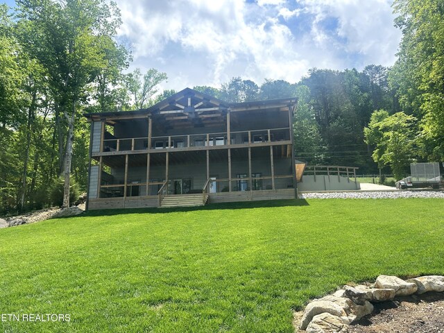 back of house featuring a yard