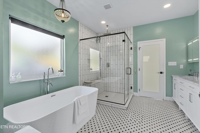 bathroom with a shower stall, a freestanding bath, vanity, recessed lighting, and a chandelier