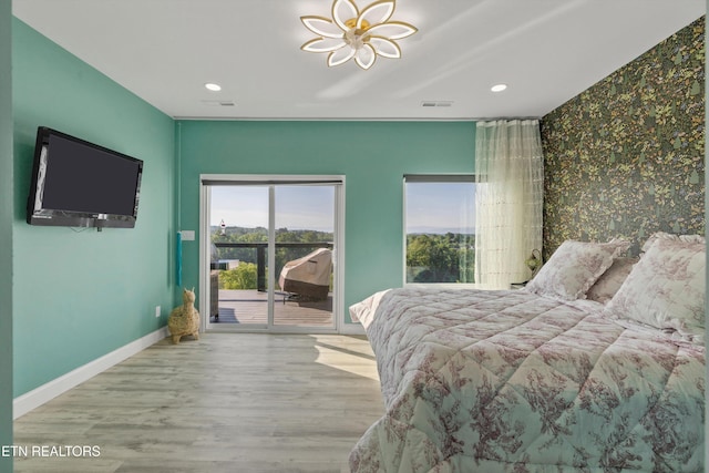 bedroom featuring access to exterior, baseboards, wood finished floors, and recessed lighting