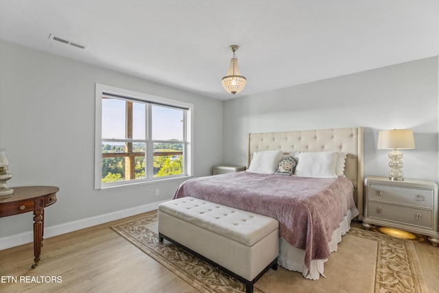 bedroom with light wood-style floors and baseboards