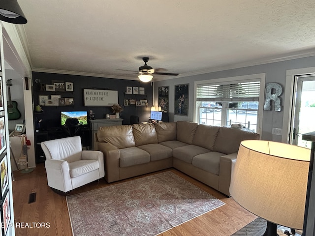 living room featuring ornamental molding, ceiling fan, and wood finished floors