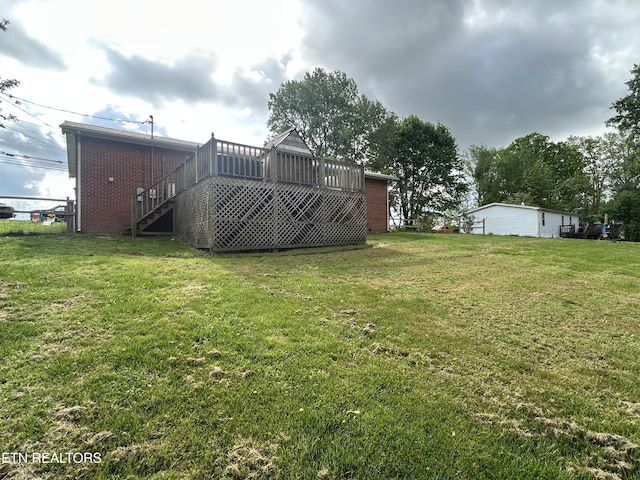 view of yard featuring a wooden deck and stairs