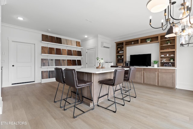 kitchen featuring crown molding, light countertops, a chandelier, light wood-style flooring, and a wall unit AC