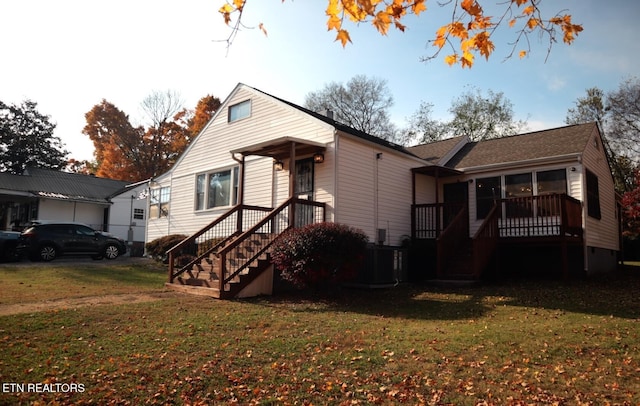 view of front of home with a front lawn, crawl space, and stairway