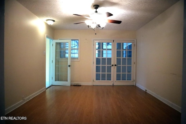 spare room featuring baseboards, french doors, and wood finished floors