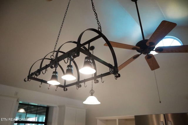 room details featuring a ceiling fan and refrigerator