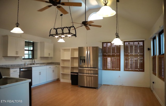 kitchen with stainless steel appliances, a ceiling fan, and high vaulted ceiling