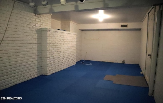 below grade area with brick wall and visible vents