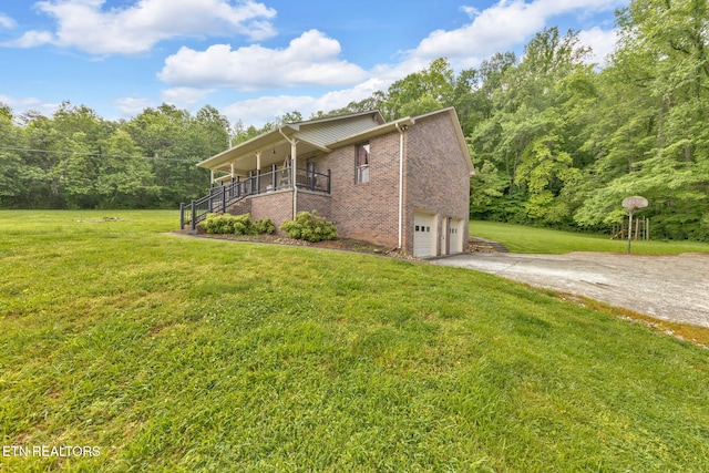 243 Bunch Ln, Clinton, TN 37716 - view of home's exterior featuring brick siding, a yard, concrete driveway, an attached garage, and stairway