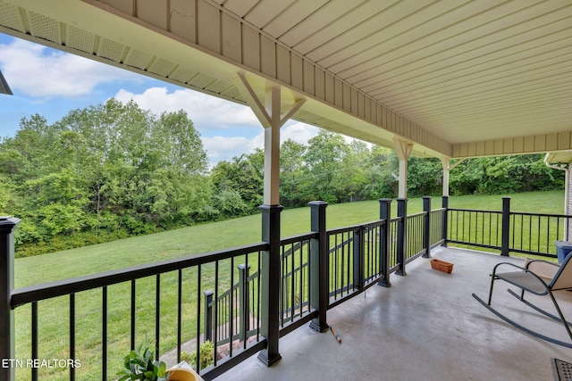 243 Bunch Ln, Clinton, TN 37716 - covered porch with a lawn and view of wooded area