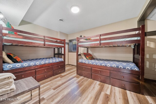 bedroom featuring light wood-style floors and visible vents