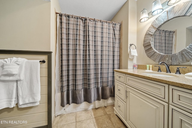 bathroom with vanity, shower / tub combo with curtain, and tile patterned flooring