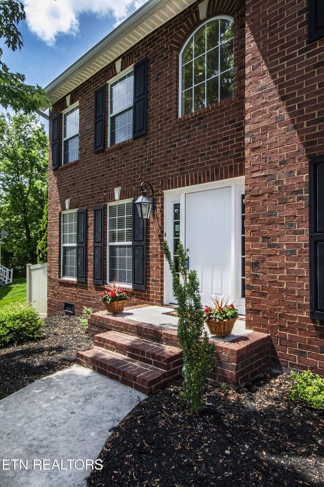colonial home featuring brick siding