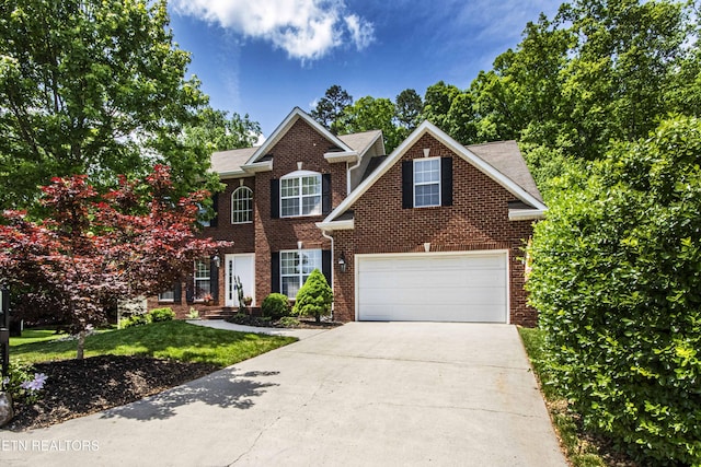 view of front of property with concrete driveway and brick siding