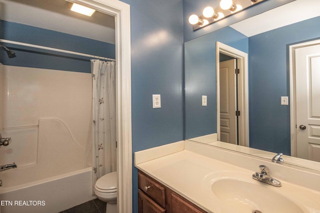bathroom featuring toilet, tile patterned floors, vanity, and shower / bath combo