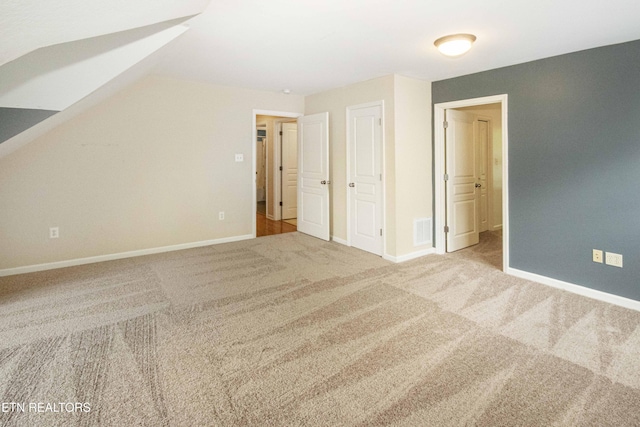 bonus room with baseboards, visible vents, carpet floors, and vaulted ceiling
