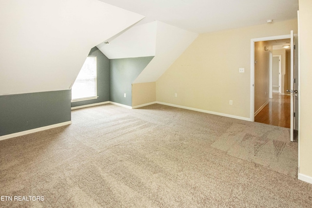 bonus room featuring carpet, vaulted ceiling, and baseboards