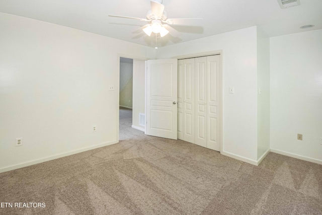unfurnished bedroom with carpet floors, baseboards, a closet, and visible vents