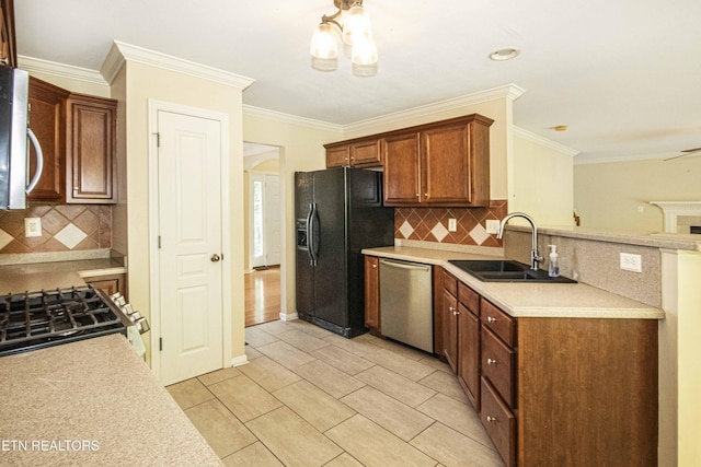 kitchen featuring a sink, stainless steel appliances, light countertops, and decorative backsplash