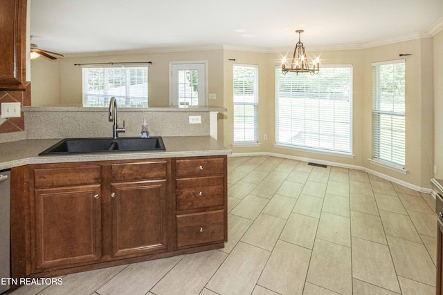 kitchen featuring a peninsula, a sink, visible vents, light countertops, and decorative backsplash