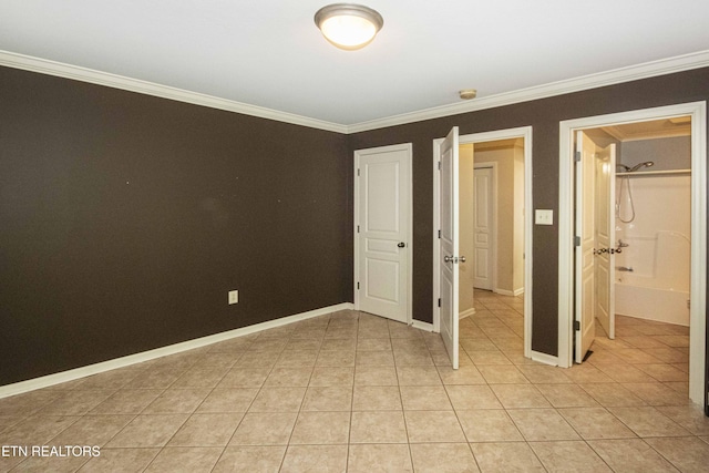 unfurnished bedroom with crown molding, baseboards, and light tile patterned flooring