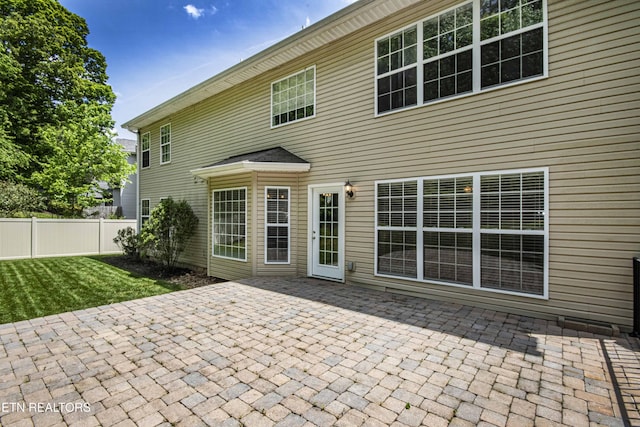 back of house with a yard, a patio area, and fence