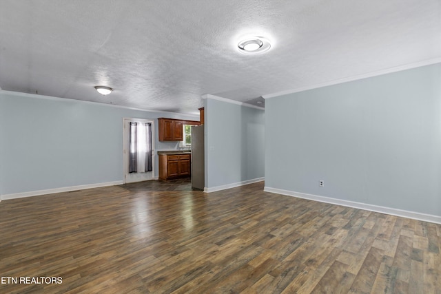 136 White Oak Dr, Harriman, TN 37748 - unfurnished living room featuring crown molding, dark wood-style flooring, a textured ceiling, and baseboards