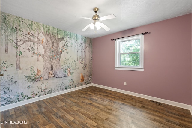 136 White Oak Dr, Harriman, TN 37748 - spare room with baseboards, wallpapered walls, and wood finished floors