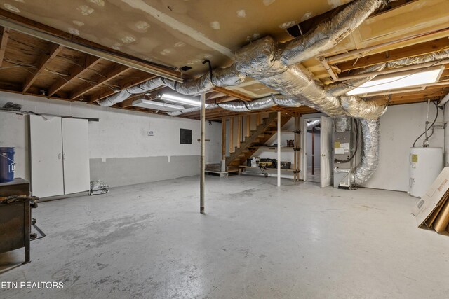 136 White Oak Dr, Harriman, TN 37748 - unfinished basement with heating unit, stairs, electric panel, and electric water heater