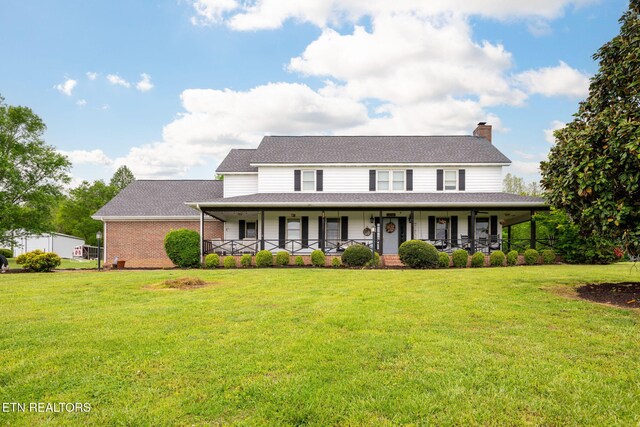 291 County Road 275, Niota, TN 37826 - view of front of house featuring a porch, a front lawn, and a chimney