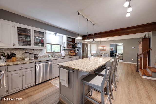 291 County Road 275, Niota, TN 37826 - kitchen with appliances with stainless steel finishes, light wood finished floors, a kitchen island, and a breakfast bar area