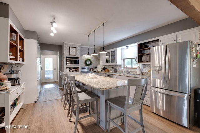 291 County Road 275, Niota, TN 37826 - kitchen featuring stainless steel appliances, open shelves, track lighting, a breakfast bar area, and light stone counters