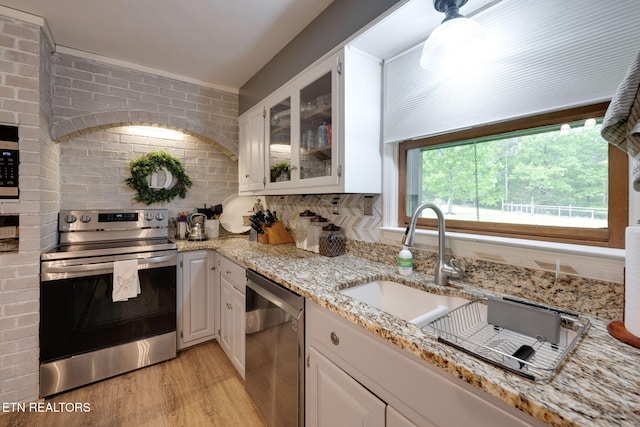291 County Road 275, Niota, TN 37826 - kitchen with stainless steel appliances, light wood-style floors, a sink, light stone counters, and white cabinets