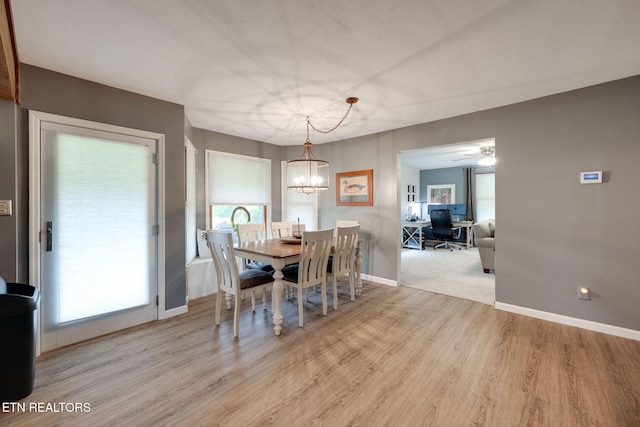 291 County Road 275, Niota, TN 37826 - dining room with light wood finished floors, a desk, a chandelier, and baseboards