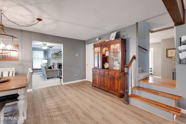291 County Road 275, Niota, TN 37826 - entrance foyer with stairway, wood finished floors, a fireplace, a ceiling fan, and baseboards