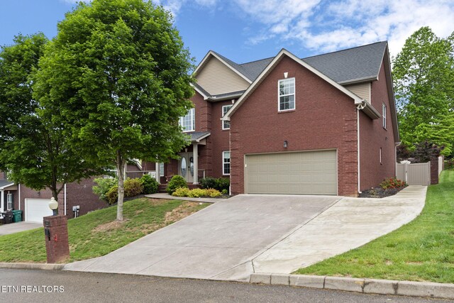 view of front of home featuring concrete driveway, brick siding, a front yard, and a garage