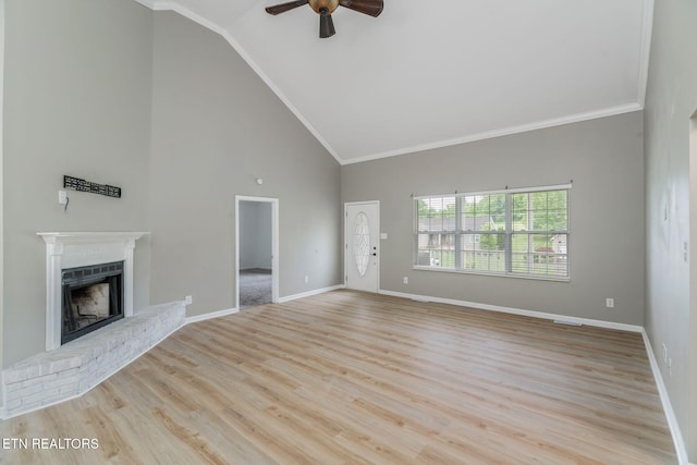 701 Misty Ridge Dr, Lenoir City, TN 37772 - unfurnished living room with a ceiling fan, a brick fireplace, high vaulted ceiling, ornamental molding, and wood finished floors