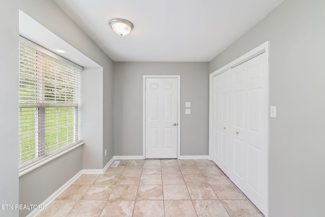 701 Misty Ridge Dr, Lenoir City, TN 37772 - unfurnished bedroom featuring a closet, baseboards, and light tile patterned floors