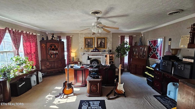 carpeted office space with visible vents, a ceiling fan, a fireplace, and ornamental molding