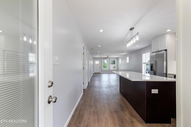 kitchen with light countertops, recessed lighting, white cabinetry, dark wood-type flooring, and stainless steel refrigerator with ice dispenser