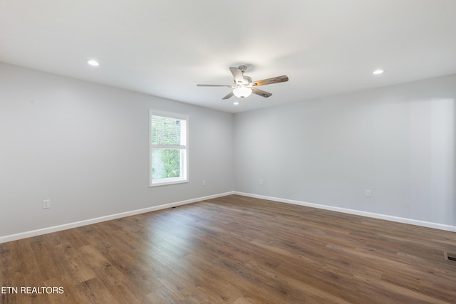 spare room featuring recessed lighting, baseboards, ceiling fan, and dark wood-style floors